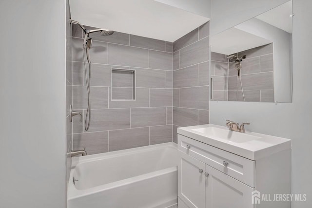 bathroom featuring shower / tub combination and vanity