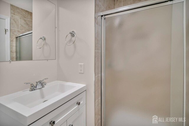 bathroom featuring a stall shower and vanity
