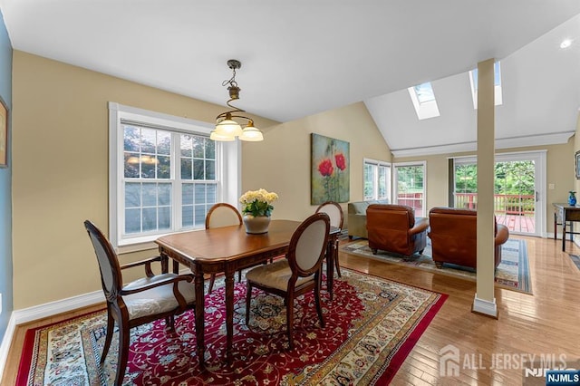 87 Fairway Blvd, Middlesex, NJ 08831 - dining area featuring a skylight, light wood finished floors, baseboards, and vaulted ceiling