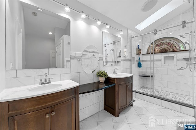 87 Fairway Blvd, Middlesex, NJ 08831 - full bathroom with two vanities, a shower stall, tile walls, and a skylight