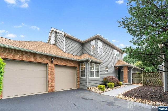 87 Fairway Blvd, Middlesex, NJ 08831 - view of front of home featuring a garage, asphalt driveway, brick siding, and a shingled roof