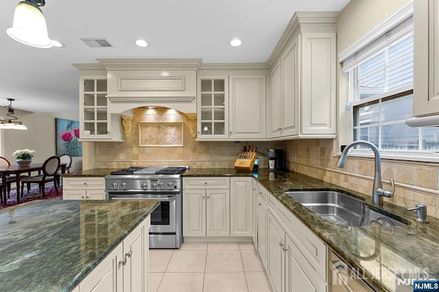 87 Fairway Blvd, Middlesex, NJ 08831 - kitchen with appliances with stainless steel finishes, a sink, light tile patterned floors, backsplash, and dark stone counters