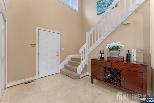 87 Fairway Blvd, Middlesex, NJ 08831 - entryway with stairway, baseboards, and a towering ceiling
