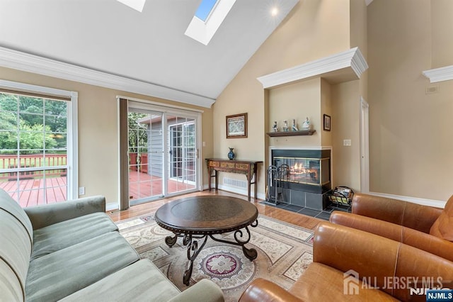 87 Fairway Blvd, Middlesex, NJ 08831 - living room with high vaulted ceiling, a fireplace with flush hearth, a skylight, wood finished floors, and baseboards