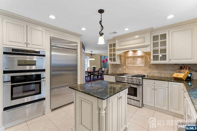 87 Fairway Blvd, Middlesex, NJ 08831 - kitchen featuring high quality appliances, a warming drawer, light tile patterned flooring, decorative backsplash, and decorative light fixtures