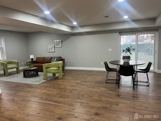 dining area with dark hardwood / wood-style flooring