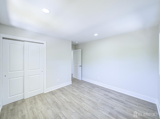 44 Sullivan Way E, Brunswick, NJ 08816 - unfurnished bedroom featuring wood finished floors, a closet, baseboards, and recessed lighting