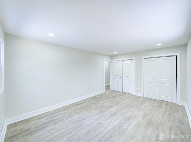 44 Sullivan Way E, Brunswick, NJ 08816 - unfurnished bedroom with multiple closets, light wood-type flooring, baseboards, and recessed lighting