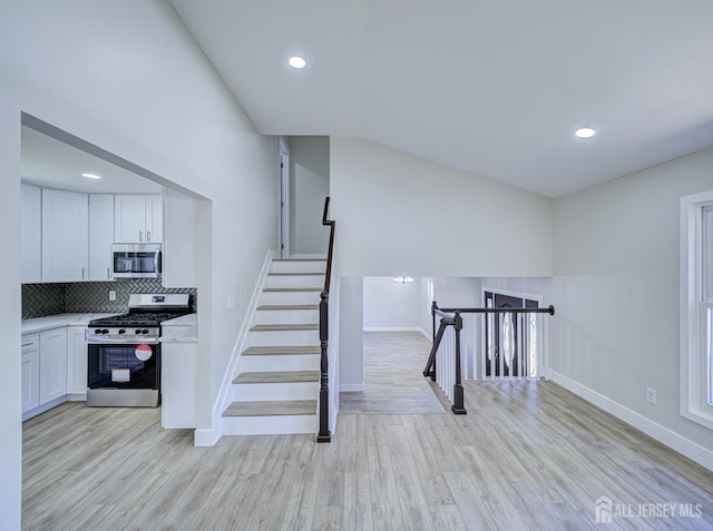 44 Sullivan Way E, Brunswick, NJ 08816 - stairway with baseboards, wood finished floors, lofted ceiling, and recessed lighting