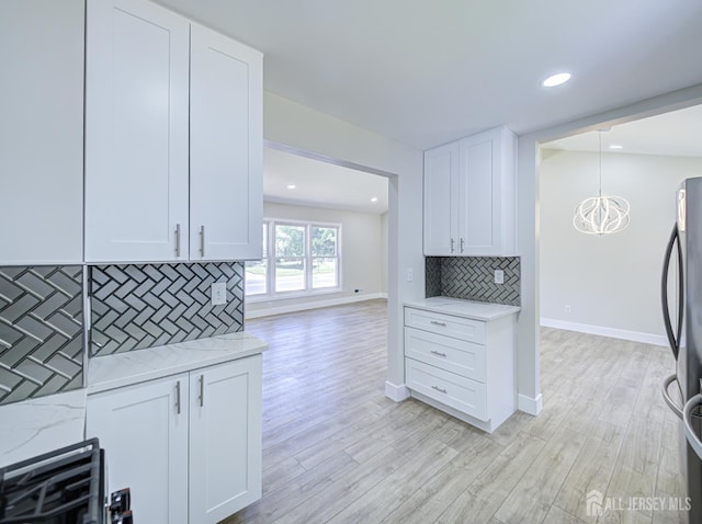 44 Sullivan Way E, Brunswick, NJ 08816 - kitchen with freestanding refrigerator, white cabinets, light wood finished floors, baseboards, and recessed lighting