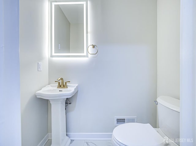44 Sullivan Way E, Brunswick, NJ 08816 - bathroom with toilet and marble look tile flooring