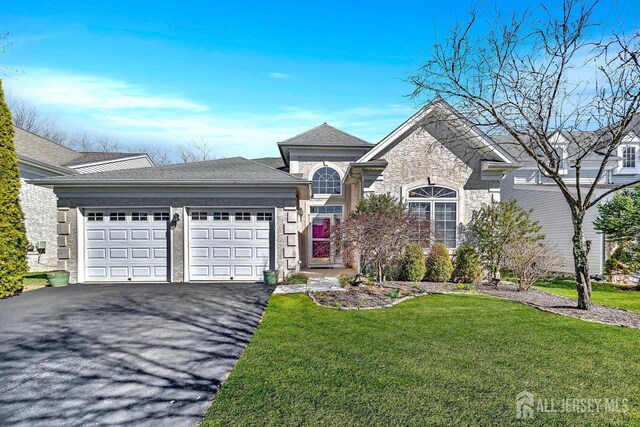 146 Aristotle Way E, Windsor, NJ 08512 - view of front of home featuring an attached garage, asphalt driveway, a front lawn, and stone siding