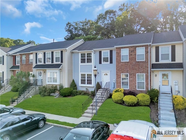 52 Lantern Ln, Sayreville, NJ 08872 - townhome / multi-family property featuring uncovered parking, stairs, brick siding, and a front lawn