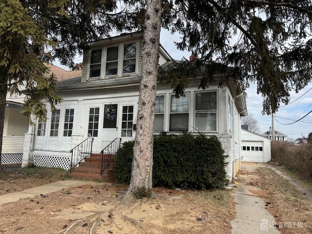 view of front of house with an outbuilding and a garage