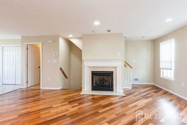 unfurnished living room with light hardwood / wood-style flooring