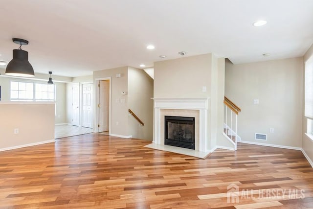 unfurnished living room with light wood-type flooring