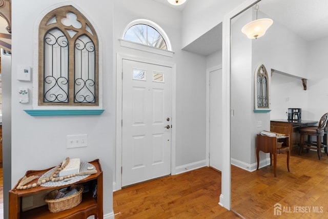 entryway featuring wood finished floors and baseboards