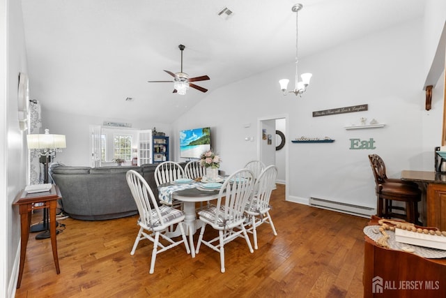 dining space with high vaulted ceiling, a baseboard heating unit, ceiling fan with notable chandelier, visible vents, and wood-type flooring