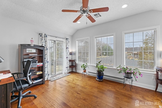 office featuring lofted ceiling, wood-type flooring, and visible vents