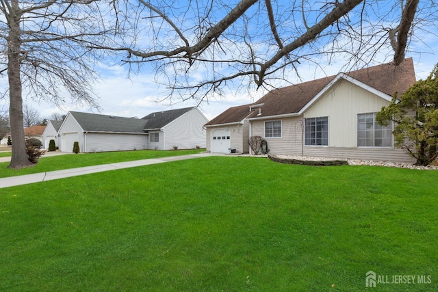 single story home with a garage, driveway, and a front lawn