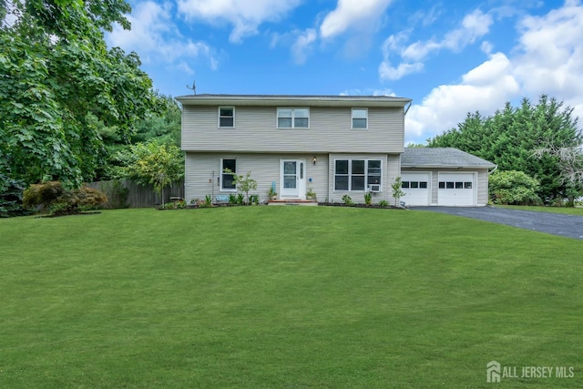 view of front of home with a front yard and a garage