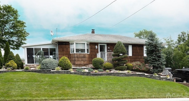 ranch-style home with a front lawn