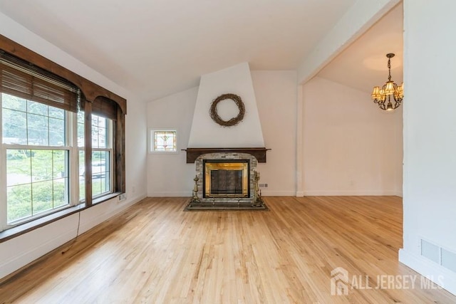 42 Corona Rd, East Brunswick, NJ 08816 - unfurnished living room featuring vaulted ceiling, a chandelier, light wood-type flooring, and a glass covered fireplace