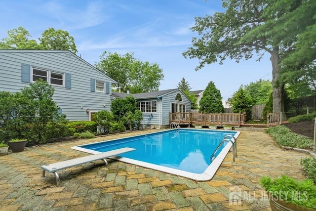 42 Corona Rd, East Brunswick, NJ 08816 - outdoor pool featuring a wooden deck, a diving board, and a patio area