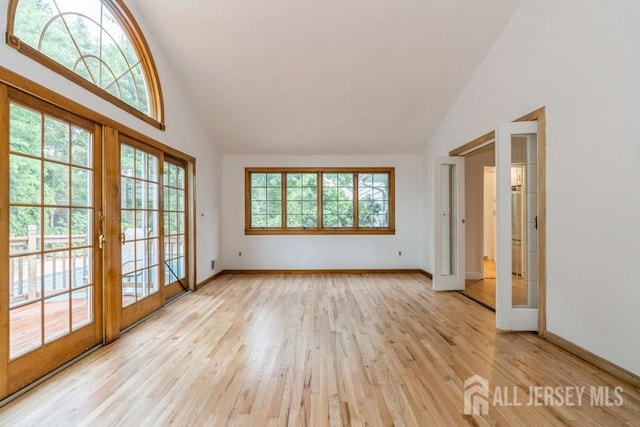 42 Corona Rd, East Brunswick, NJ 08816 - empty room with high vaulted ceiling, light wood-type flooring, and french doors