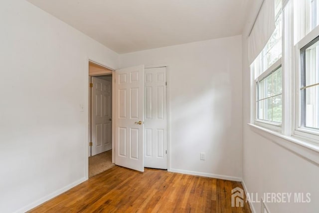 42 Corona Rd, East Brunswick, NJ 08816 - unfurnished bedroom with baseboards and light wood-style flooring