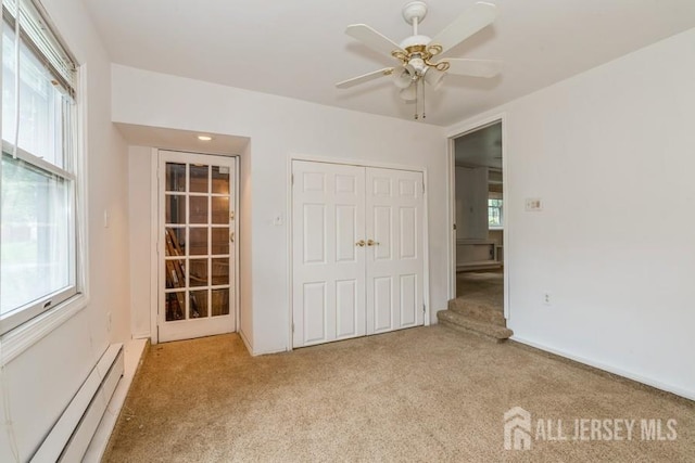 42 Corona Rd, East Brunswick, NJ 08816 - unfurnished bedroom featuring baseboard heating, carpet flooring, a closet, and a ceiling fan