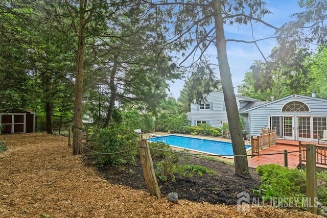 42 Corona Rd, East Brunswick, NJ 08816 - outdoor pool with a deck and a storage shed