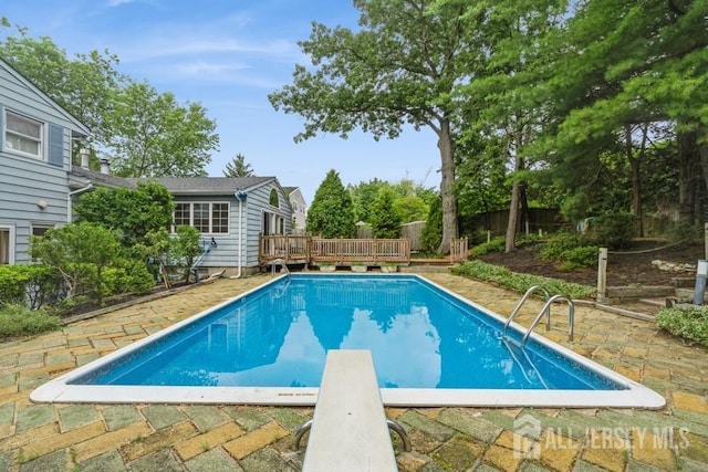 42 Corona Rd, East Brunswick, NJ 08816 - view of swimming pool with a deck, a diving board, and a fenced backyard