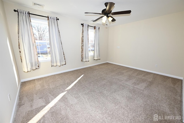 carpeted empty room with a healthy amount of sunlight and ceiling fan