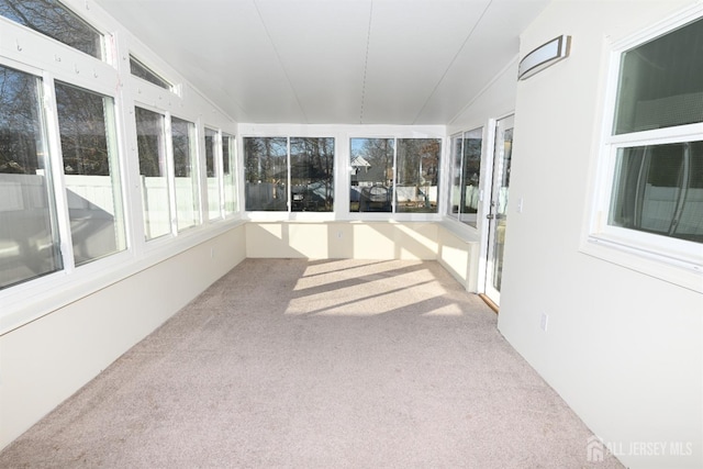 unfurnished sunroom featuring lofted ceiling