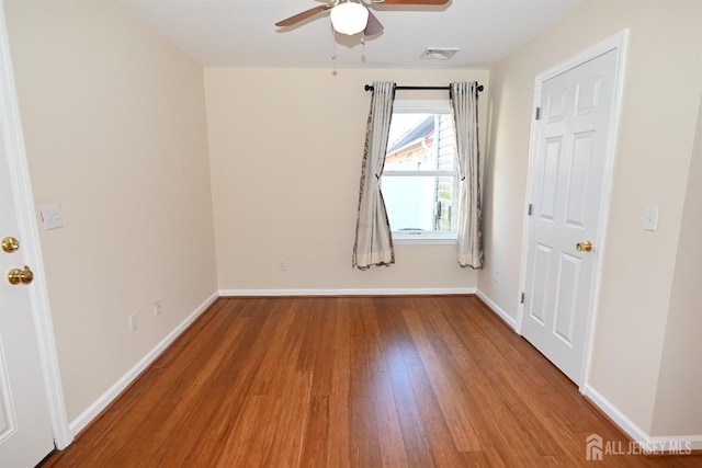 spare room with ceiling fan and wood-type flooring