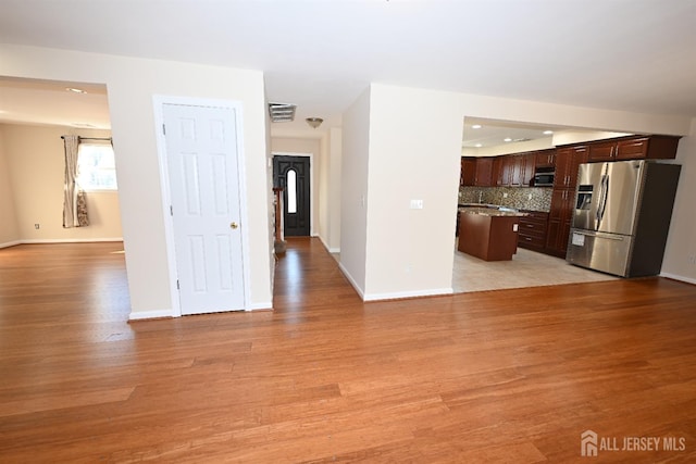 unfurnished living room with light wood-type flooring