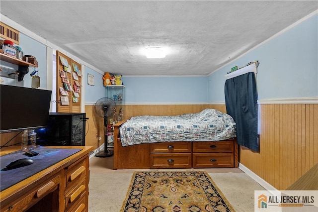 28 Wildwood Ave, Fords, NJ 08863 - bedroom with a textured ceiling, wainscoting, and wooden walls
