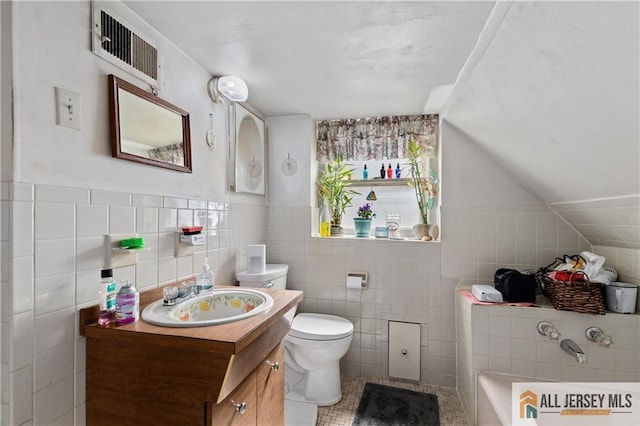 28 Wildwood Ave, Fords, NJ 08863 - bathroom with vanity, tile walls, a bath, lofted ceiling, and tile patterned floors