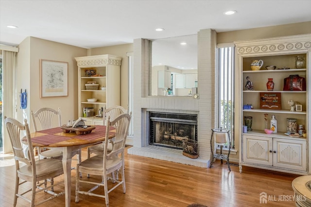 441 Sayre Dr, Plainsboro, NJ 08540 - dining space featuring a fireplace, light wood finished floors, and recessed lighting