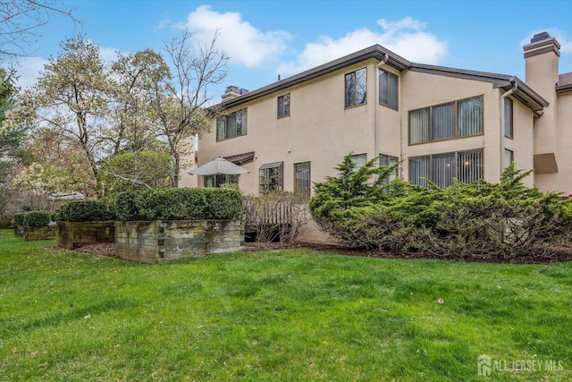 441 Sayre Dr, Plainsboro, NJ 08540 - rear view of property featuring a chimney, a lawn, and stucco siding
