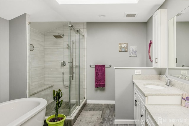 441 Sayre Dr, Plainsboro, NJ 08540 - bathroom featuring wood finished floors, vanity, a shower stall, and baseboards