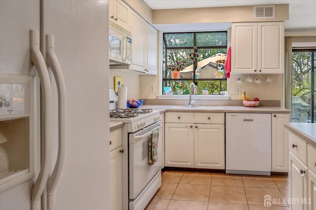 441 Sayre Dr, Plainsboro, NJ 08540 - kitchen with white appliances, a sink, light countertops, light tile patterned floors, and white cabinets
