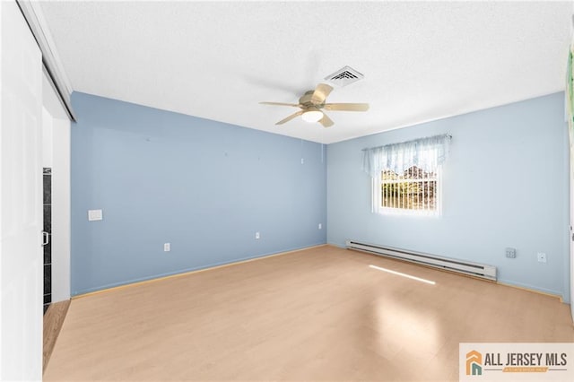 703 Croydon Rd Unit 703B, Monroe, NJ 08831 - empty room featuring baseboard heating, ceiling fan, wood finished floors, and a textured ceiling