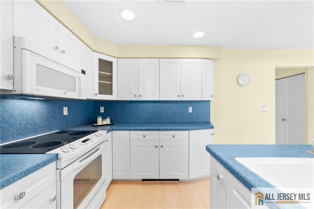 703 Croydon Rd Unit 703B, Monroe, NJ 08831 - kitchen featuring white appliances, white cabinetry, tasteful backsplash, glass insert cabinets, and recessed lighting