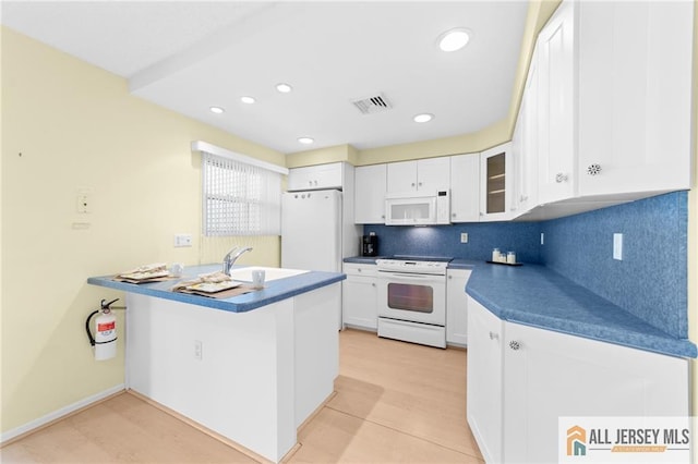703 Croydon Rd Unit 703B, Monroe, NJ 08831 - kitchen featuring white appliances, white cabinetry, backsplash, glass insert cabinets, and dark countertops