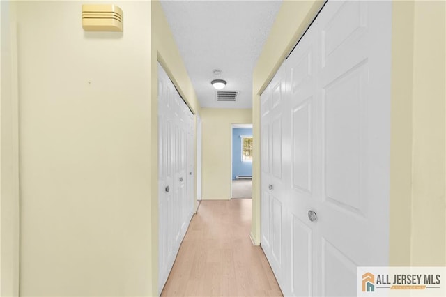 703 Croydon Rd Unit 703B, Monroe, NJ 08831 - hallway featuring light wood-type flooring and baseboard heating
