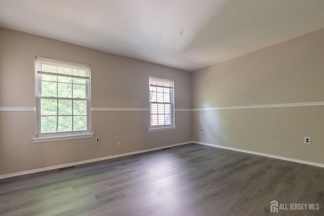 72 Morgan Pl E, Brunswick, NJ 08816 - empty room featuring dark wood finished floors and baseboards
