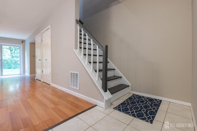 72 Morgan Pl E, Brunswick, NJ 08816 - staircase with baseboards and wood finished floors
