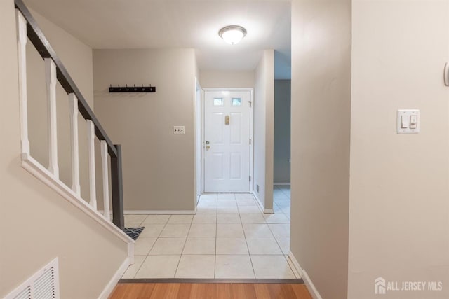 72 Morgan Pl E, Brunswick, NJ 08816 - foyer with light tile patterned floors and stairway